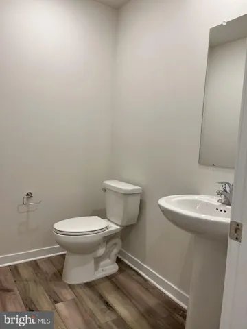a white toilet sitting next to a white sink