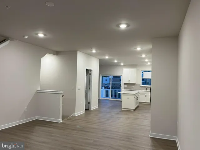 a view of a kitchen with a sink and wooden floor