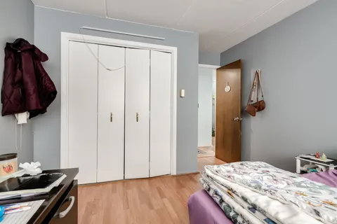 a view of a hallway with closet and a livingroom view