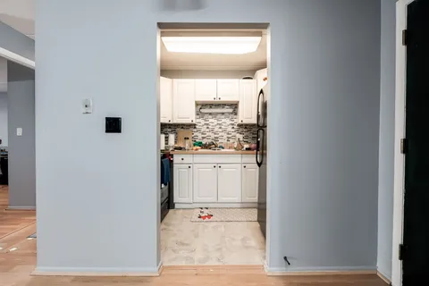 a kitchen with stainless steel appliances a sink and cabinets