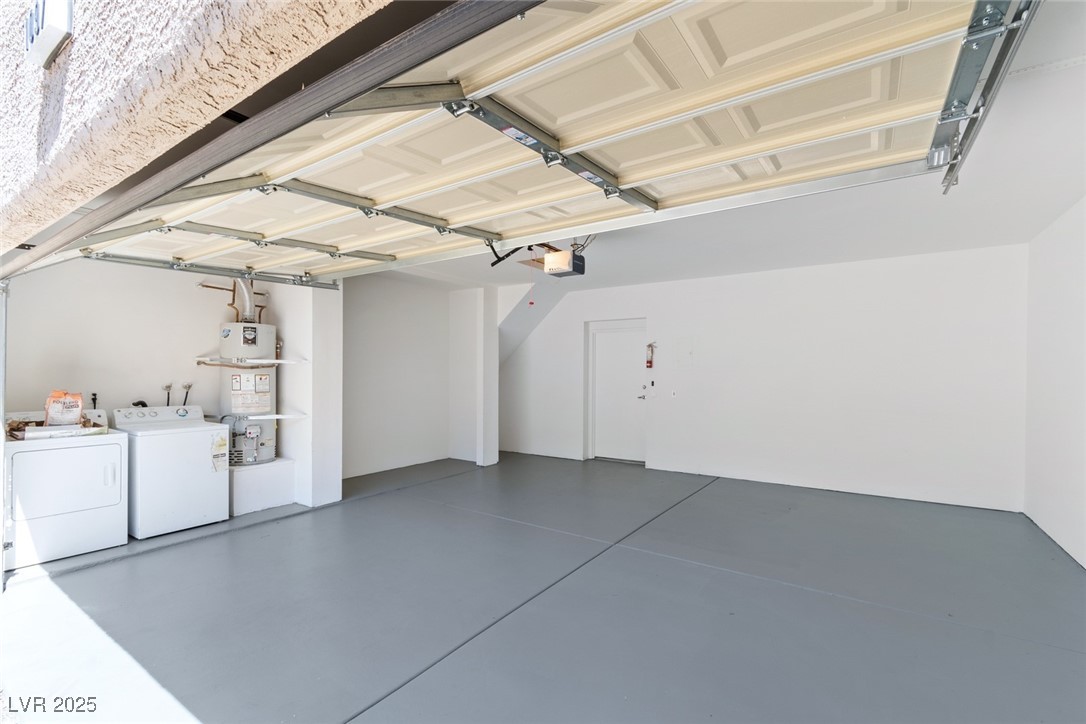 5250 South Rainbow Boulevard, Unit 1097 Las Vegas, NV 89118 - Photo 7 of 10 Garage featuring secured water heater and washer and dryer