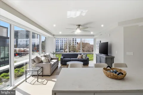 a kitchen with stainless steel appliances granite countertop a sink a stove a refrigerator cabinets and chairs