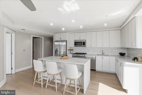 a living room with furniture flat screen tv and a large window