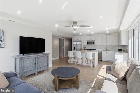a living room with furniture and a floor to ceiling window