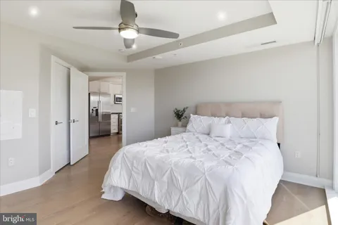 a bathroom with a granite countertop sink mirror and toilet