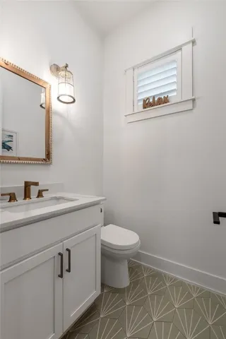 a bathroom with a double vanity sink a toilet a tub and shower
