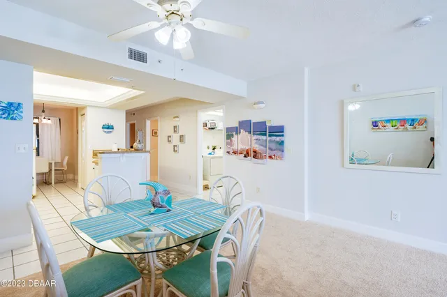 a view of a dining room with furniture and a chandelier