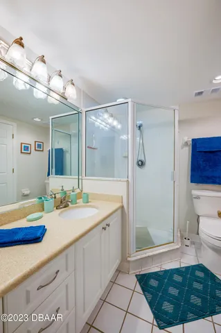 a spacious bathroom with a mirror a sink and a glass door shower