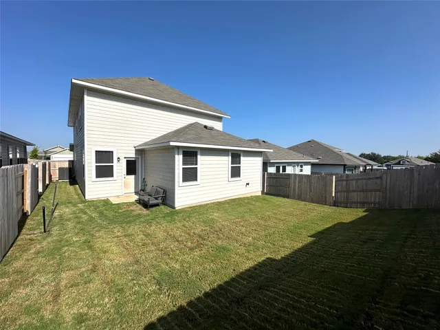 a view of a backyard of the house