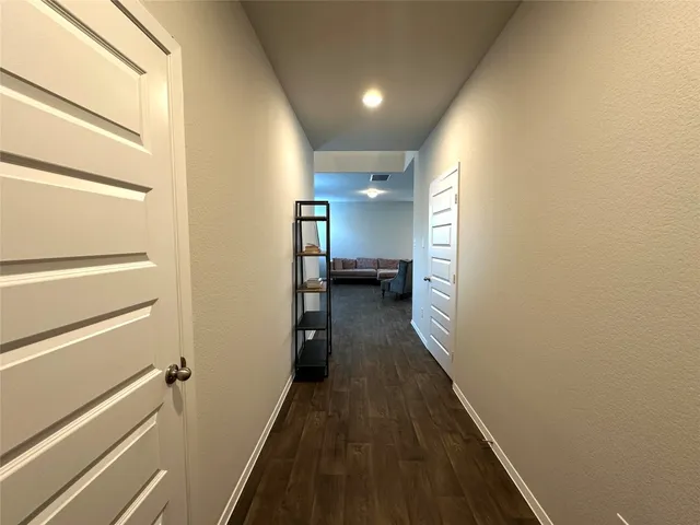 a view of hallway with wooden floor