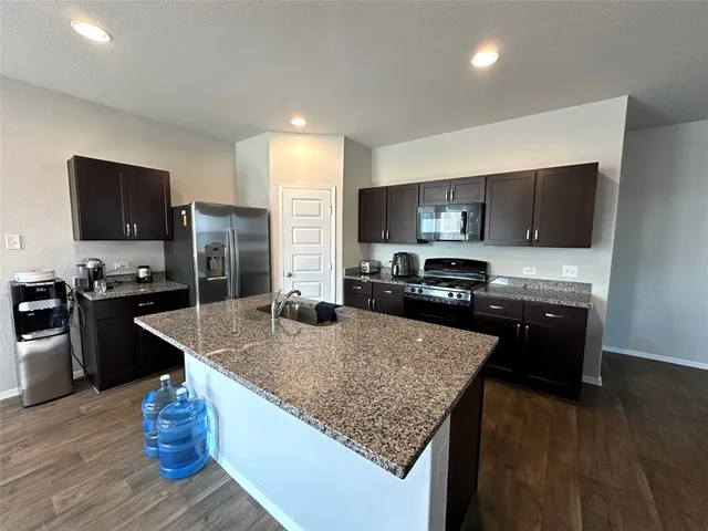 a living room with furniture and kitchen view