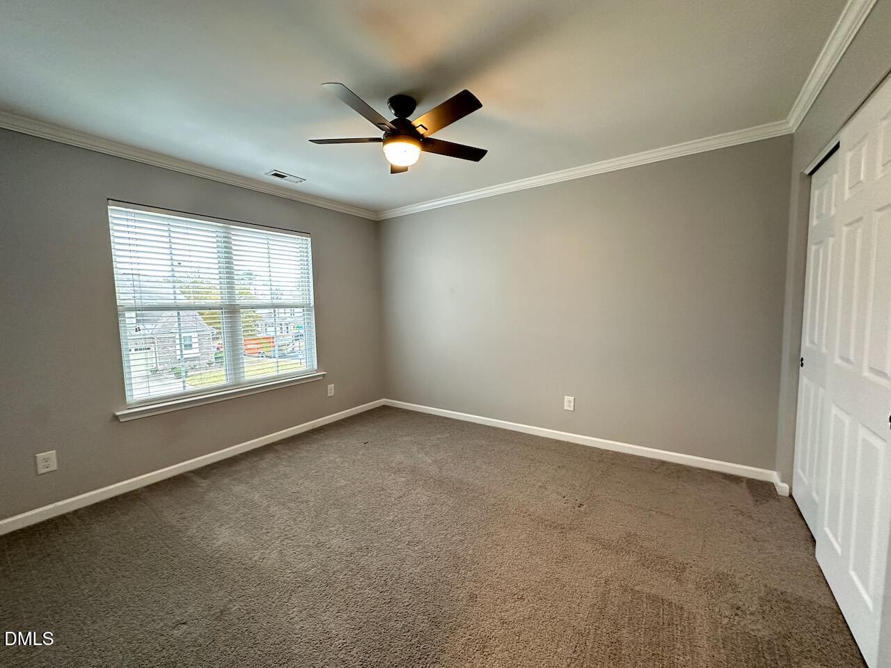 2705 Casper Creek Lane Raleigh, NC 27616 - Photo 20 of 35 an empty room with windows and fan