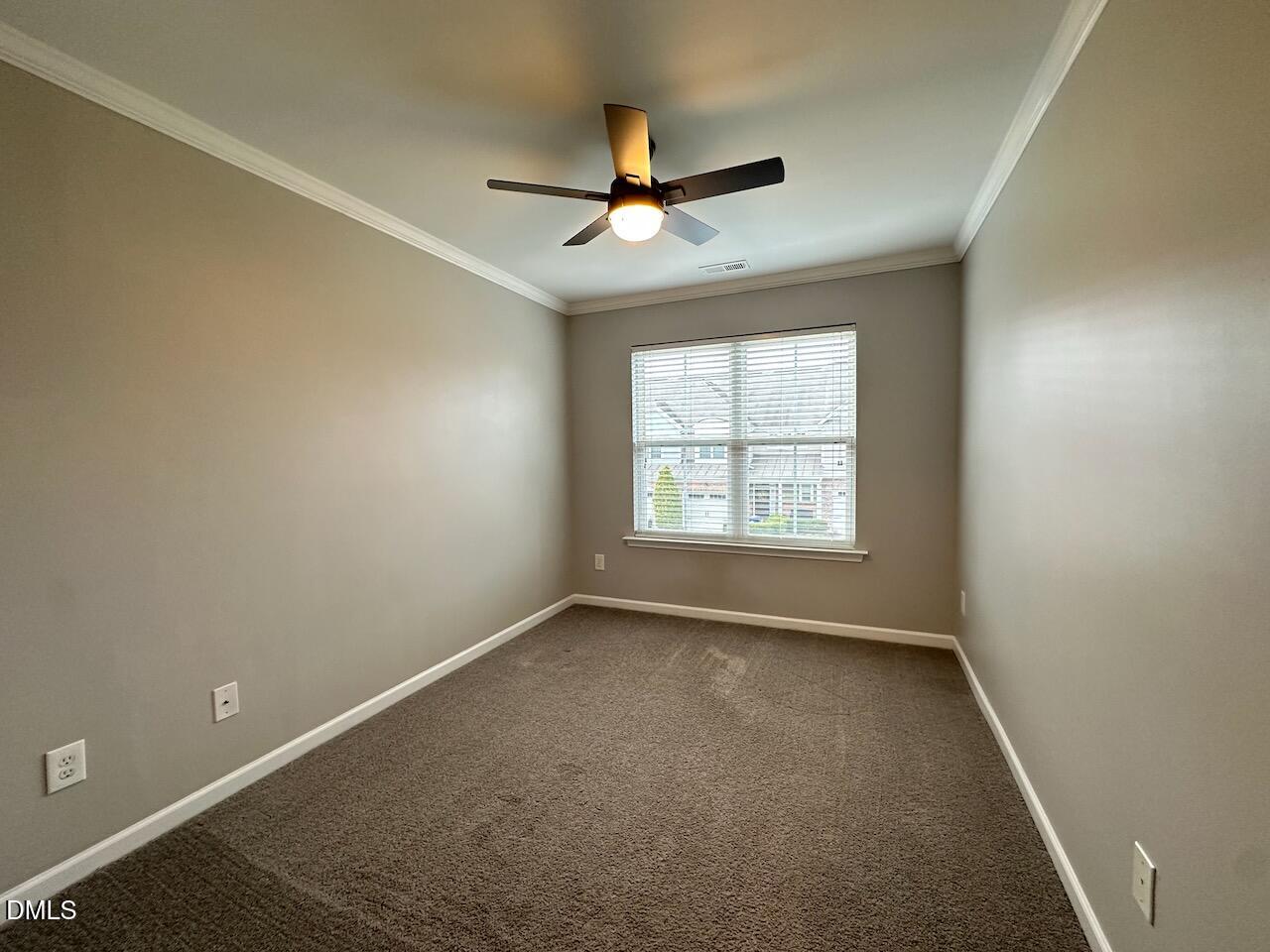2705 Casper Creek Lane Raleigh, NC 27616 - Photo 23 of 35 an empty room with ceiling fan and windows