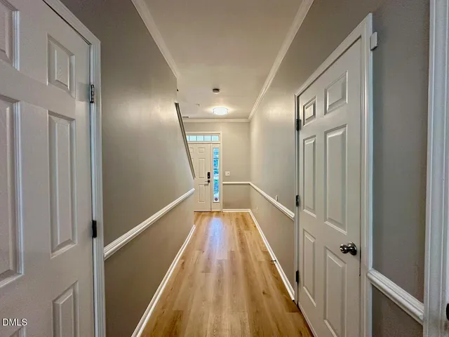 a view of a hallway with wooden floor and staircase