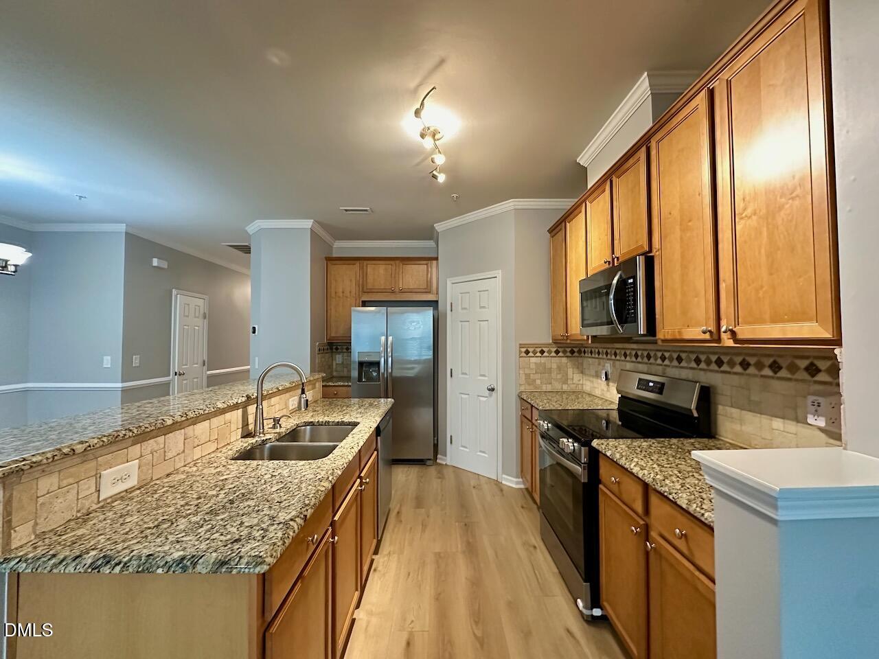 2705 Casper Creek Lane Raleigh, NC 27616 - Photo 7 of 35 a kitchen with a sink stove and cabinets