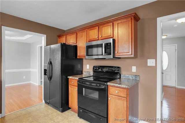a kitchen with stainless steel appliances granite countertop a refrigerator stove and microwave
