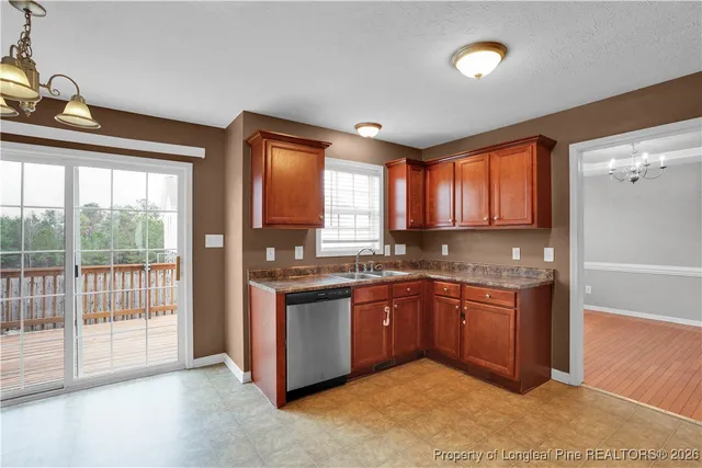 a large kitchen with stainless steel appliances granite countertop a stove a sink and a refrigerator