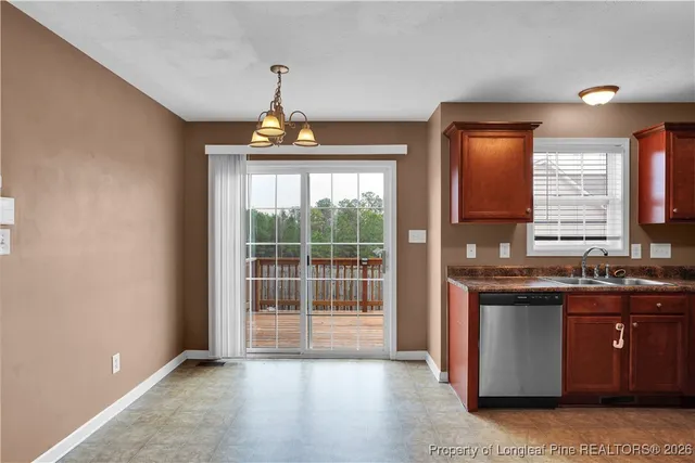 a kitchen with stainless steel appliances granite countertop a stove a sink and a window