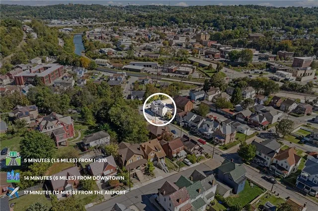 an aerial view of a residential houses with outdoor space and street view