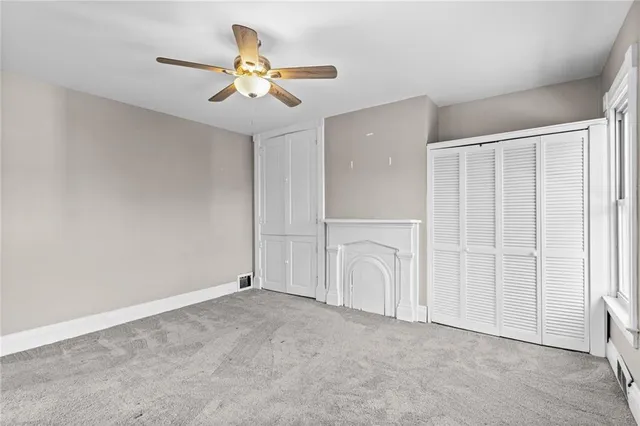 an empty room with closet and entryway