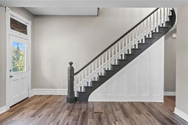 a view of entryway and hall with wooden floor