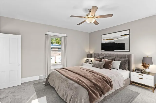 a bedroom with a large bed and a window