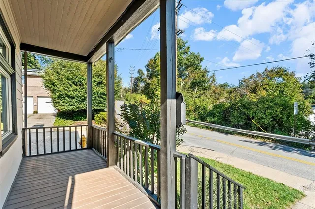 a view of a balcony with wooden floor