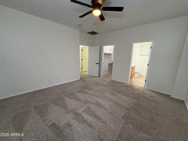 a view of a livingroom with a ceiling fan and window