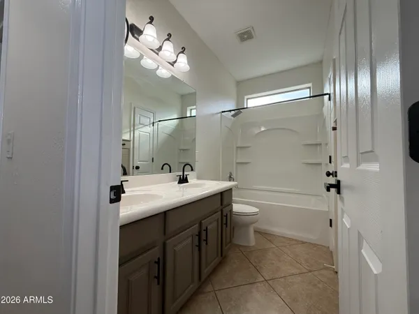 a bathroom with a double vanity sink mirror double and shower
