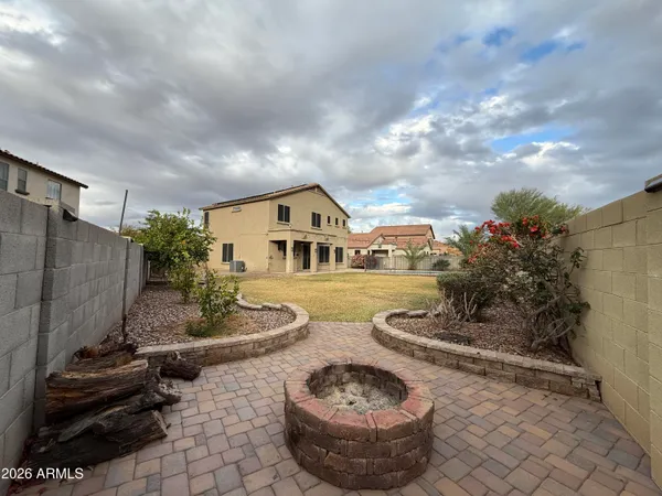 a very nice looking yard with wooden fence