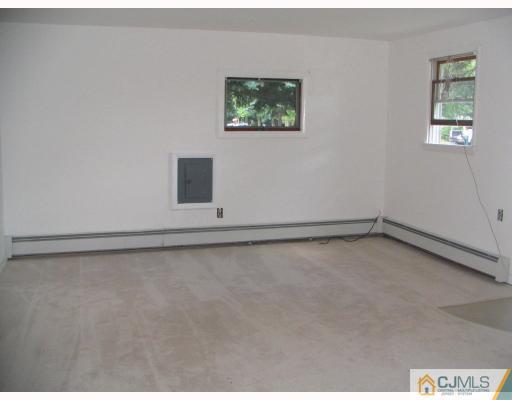 1597 Holly Road North Brunswick, NJ 08902 - Photo 5 of 9 a view of an empty room with a window