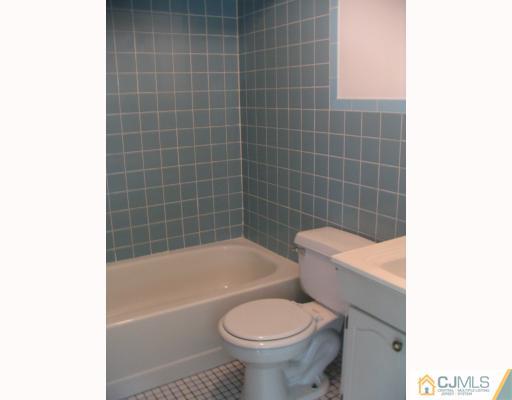 1597 Holly Road North Brunswick, NJ 08902 - Photo 7 of 9 a bathroom with a bathtub and toilet