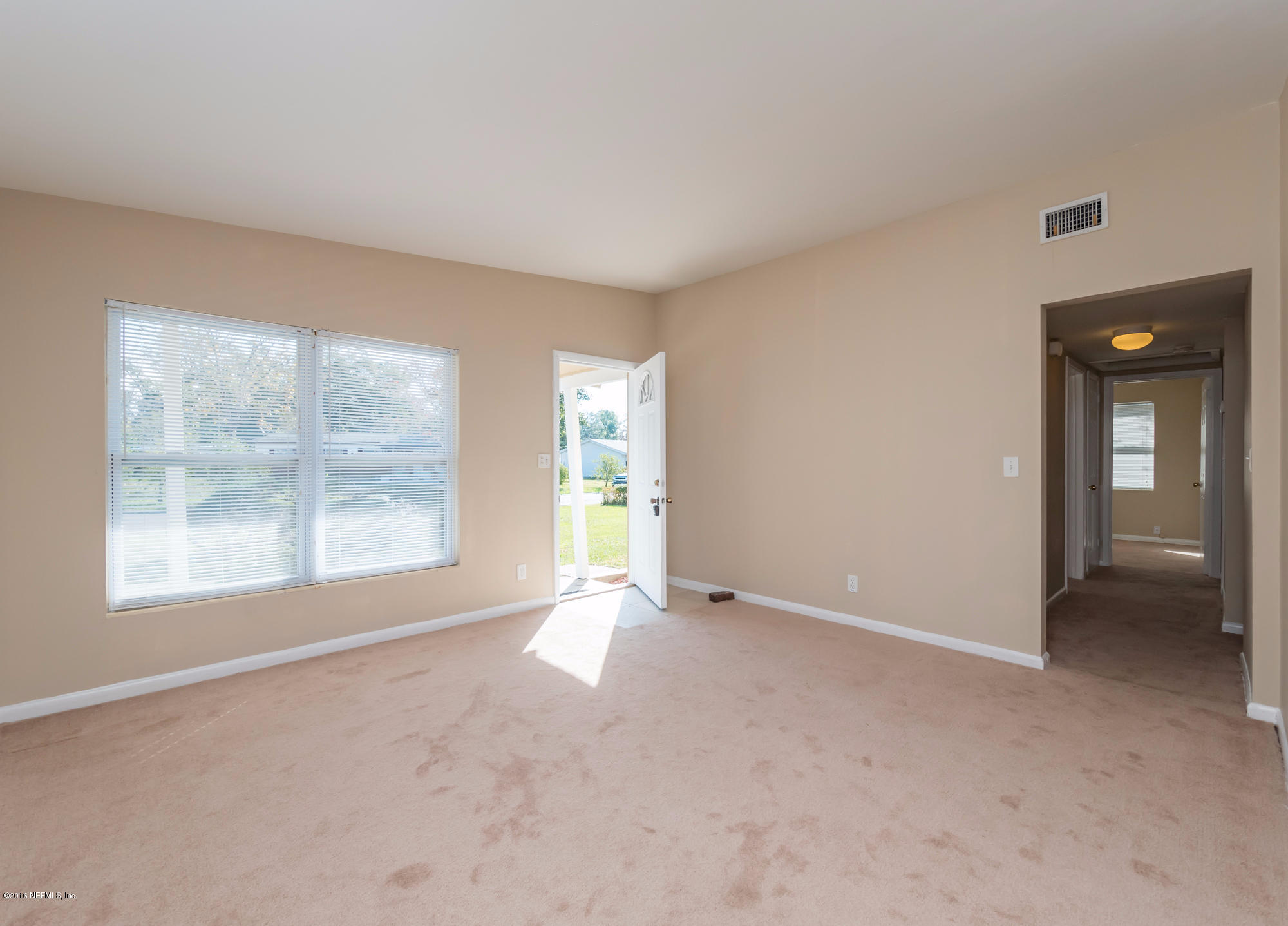 10474 Dodd Road Jacksonville, FL 32218 - Photo 3 of 26 an empty room with windows and entrance