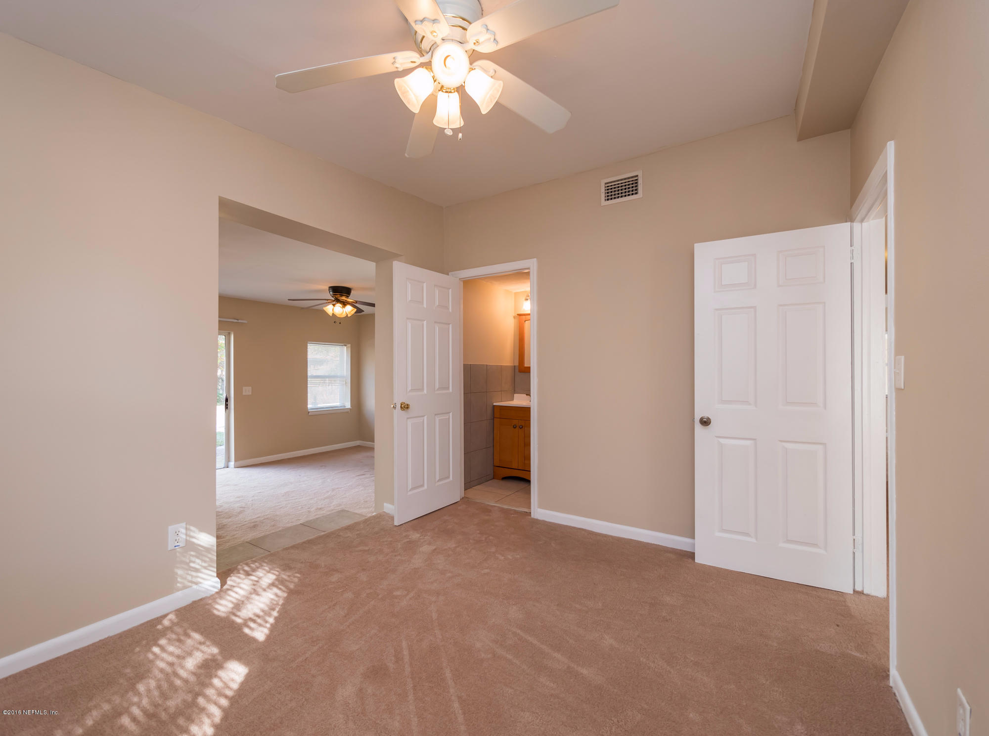 10474 Dodd Road Jacksonville, FL 32218 - Photo 10 of 26 a view of a big room with wooden floor and closet area