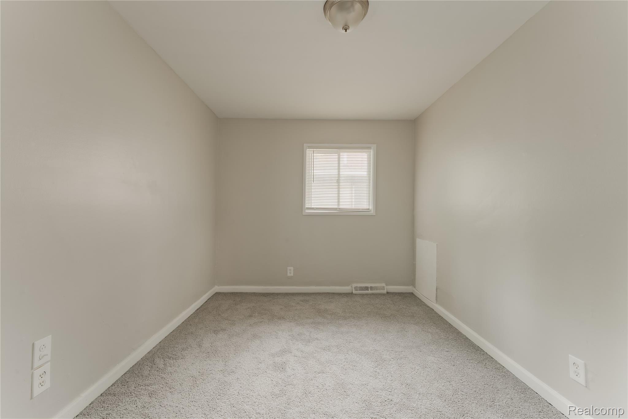 93 West Princeton Avenue Pontiac, MI 48340 - Photo 16 of 31 Neutral gray walls complement the gray carpeting