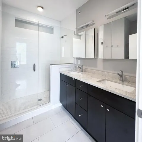 a bathroom with a granite countertop sink mirror and double