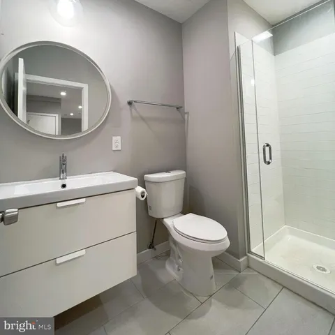a bathroom with a toilet sink and shower