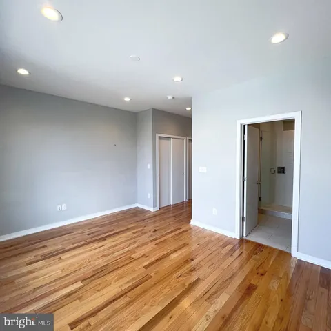 a view of an empty room and wooden floor