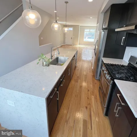 a kitchen with granite countertop a stove and a sink