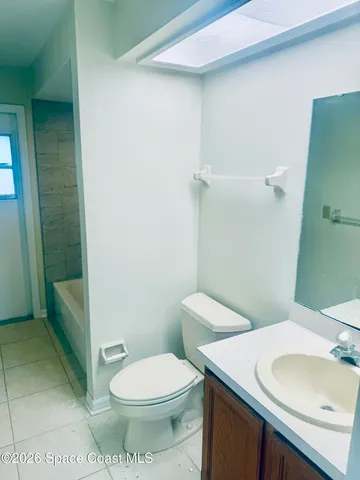 a white toilet sitting next to a bathroom sink