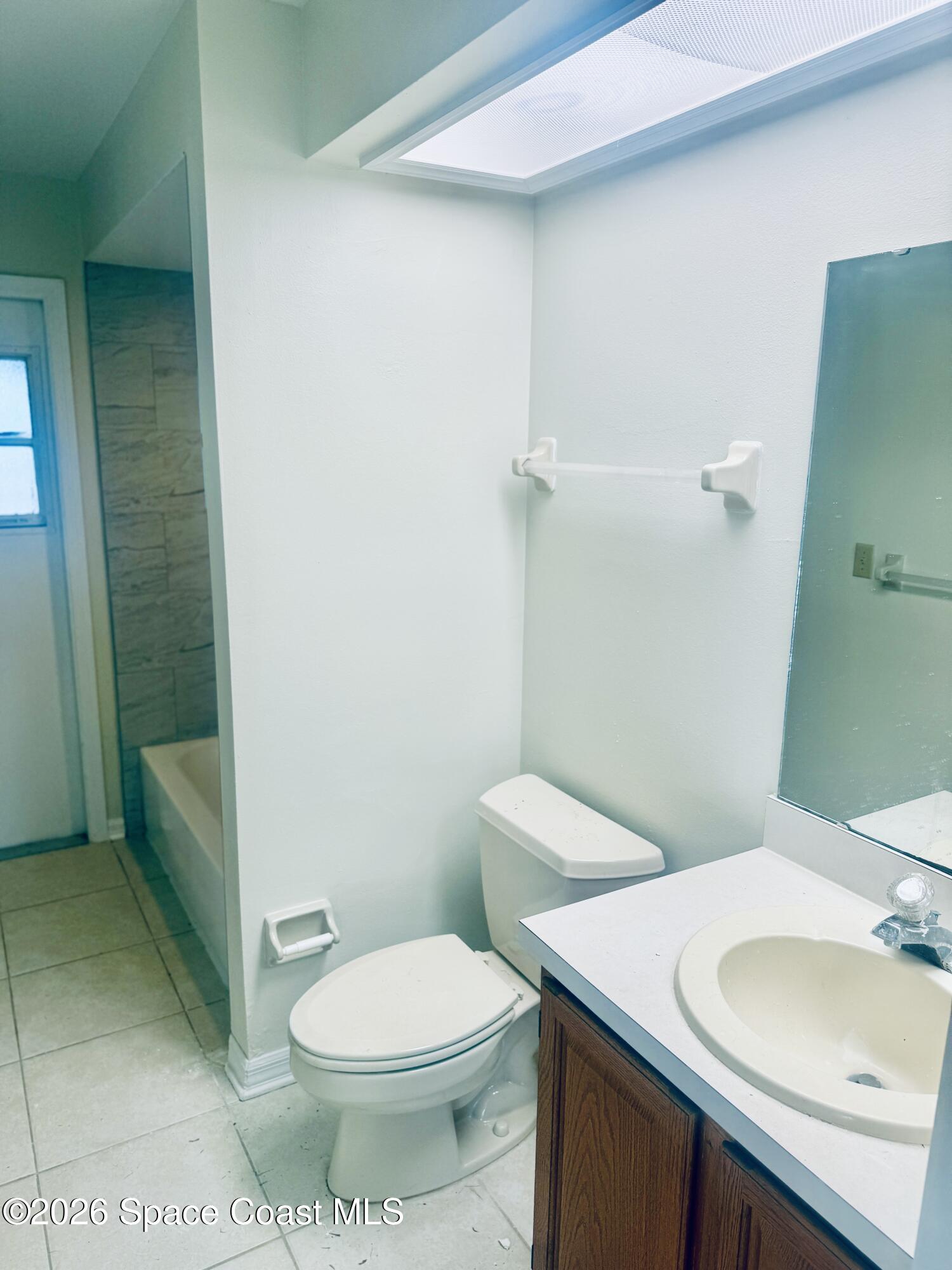 4795 Riverside Road Palm Shores, FL 32935 - Photo 19 of 33 a white toilet sitting next to a bathroom sink