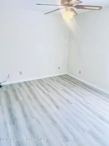 a view of a room with a ceiling fan