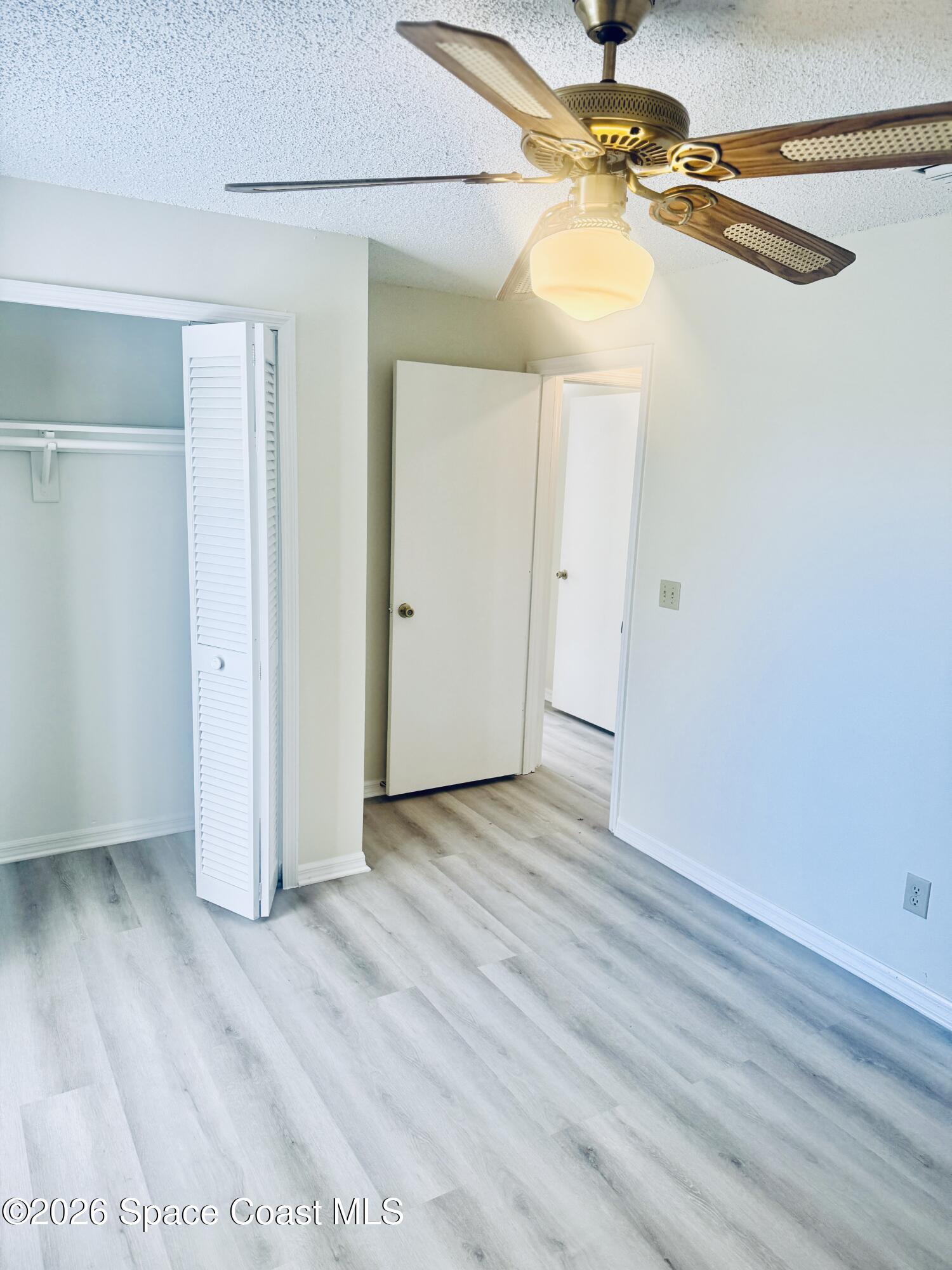 4795 Riverside Road Palm Shores, FL 32935 - Photo 24 of 33 a view of a room with wooden floor and a ceiling fan