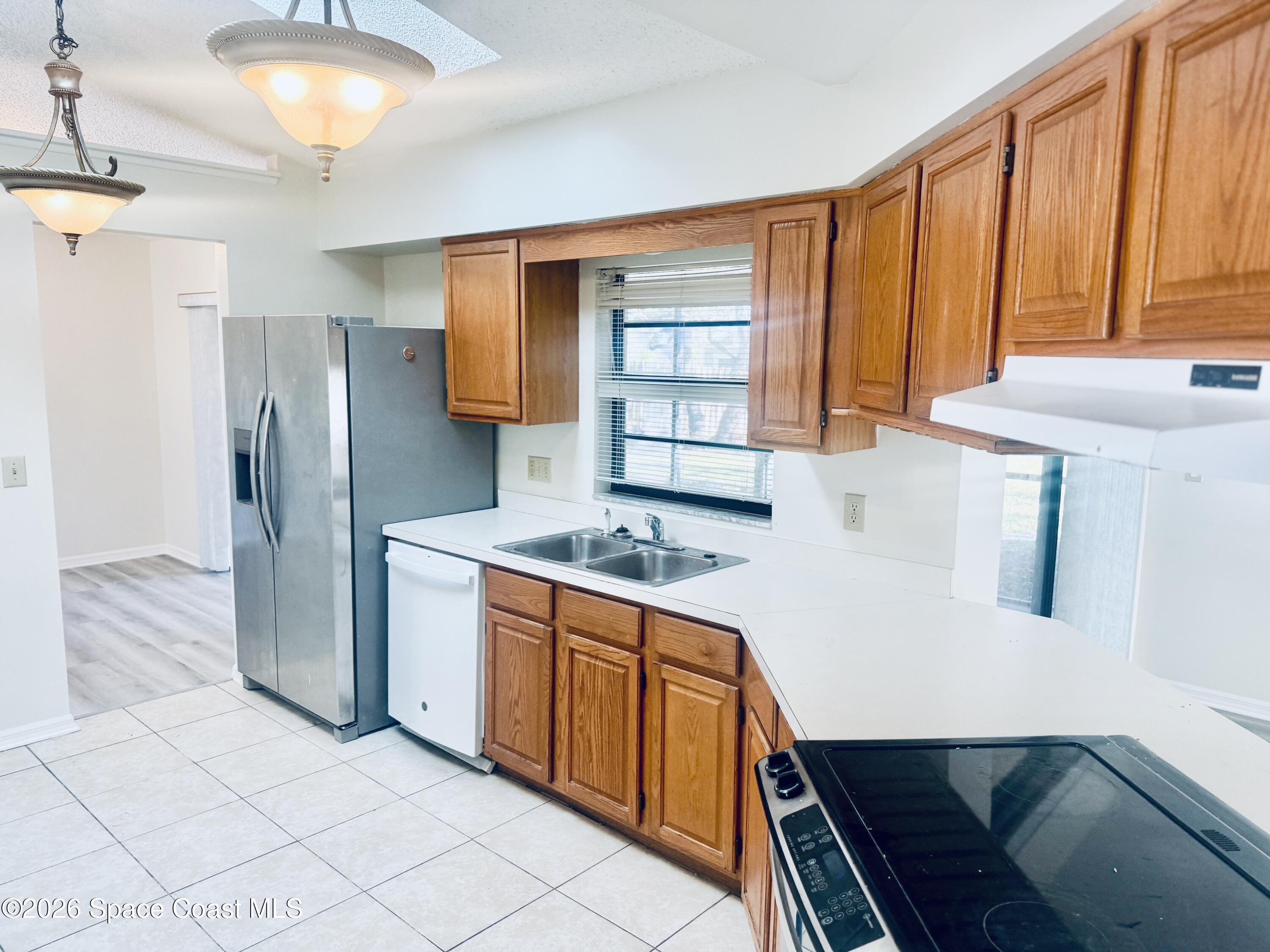 4795 Riverside Road Palm Shores, FL 32935 - Photo 8 of 33 a kitchen with stainless steel appliances a stove a refrigerator and cabinets