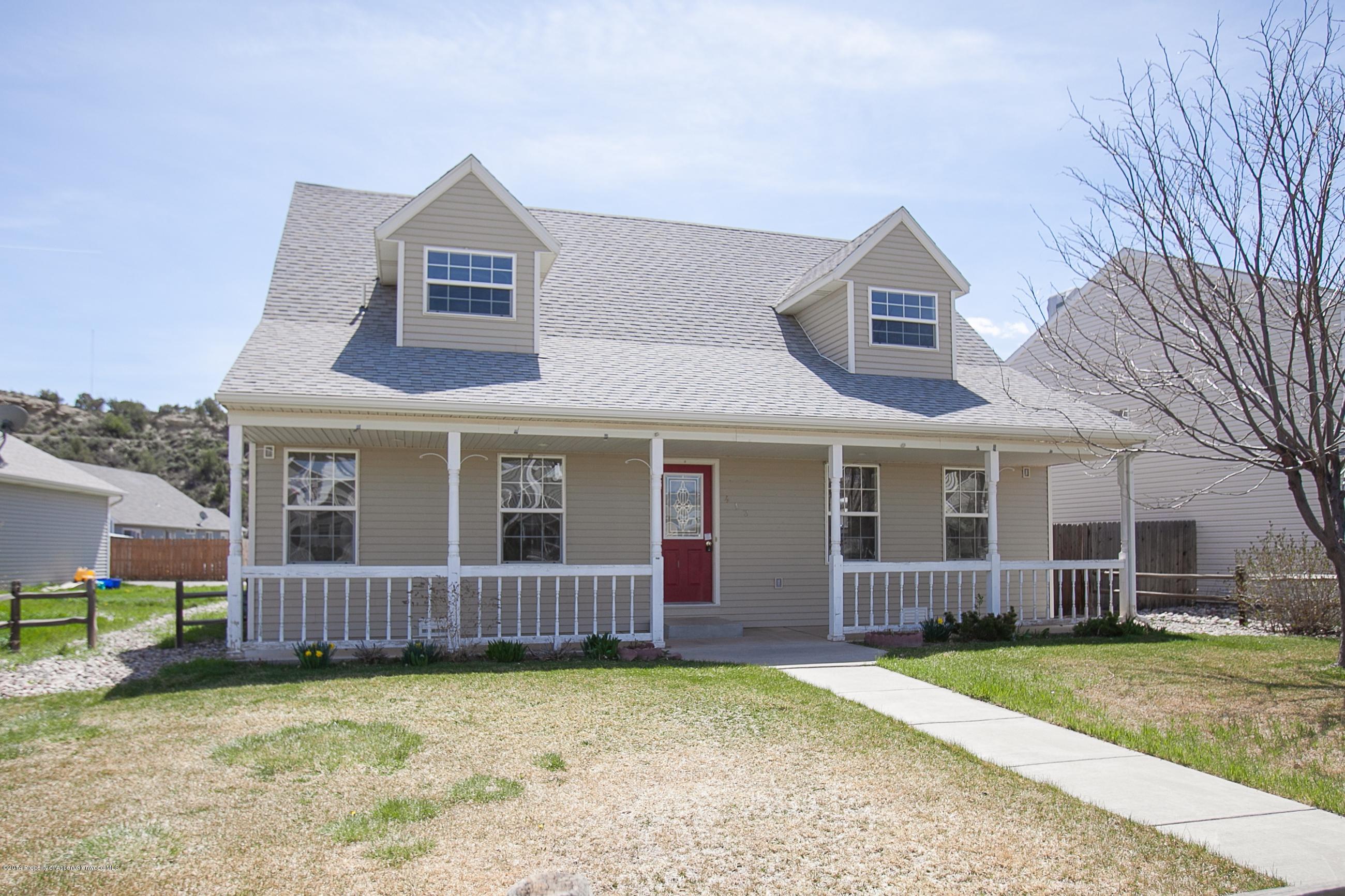 413 Evergreen Drive Rifle, CO 81650 - Photo 1 of 19 a view of a house with a yard and large tree