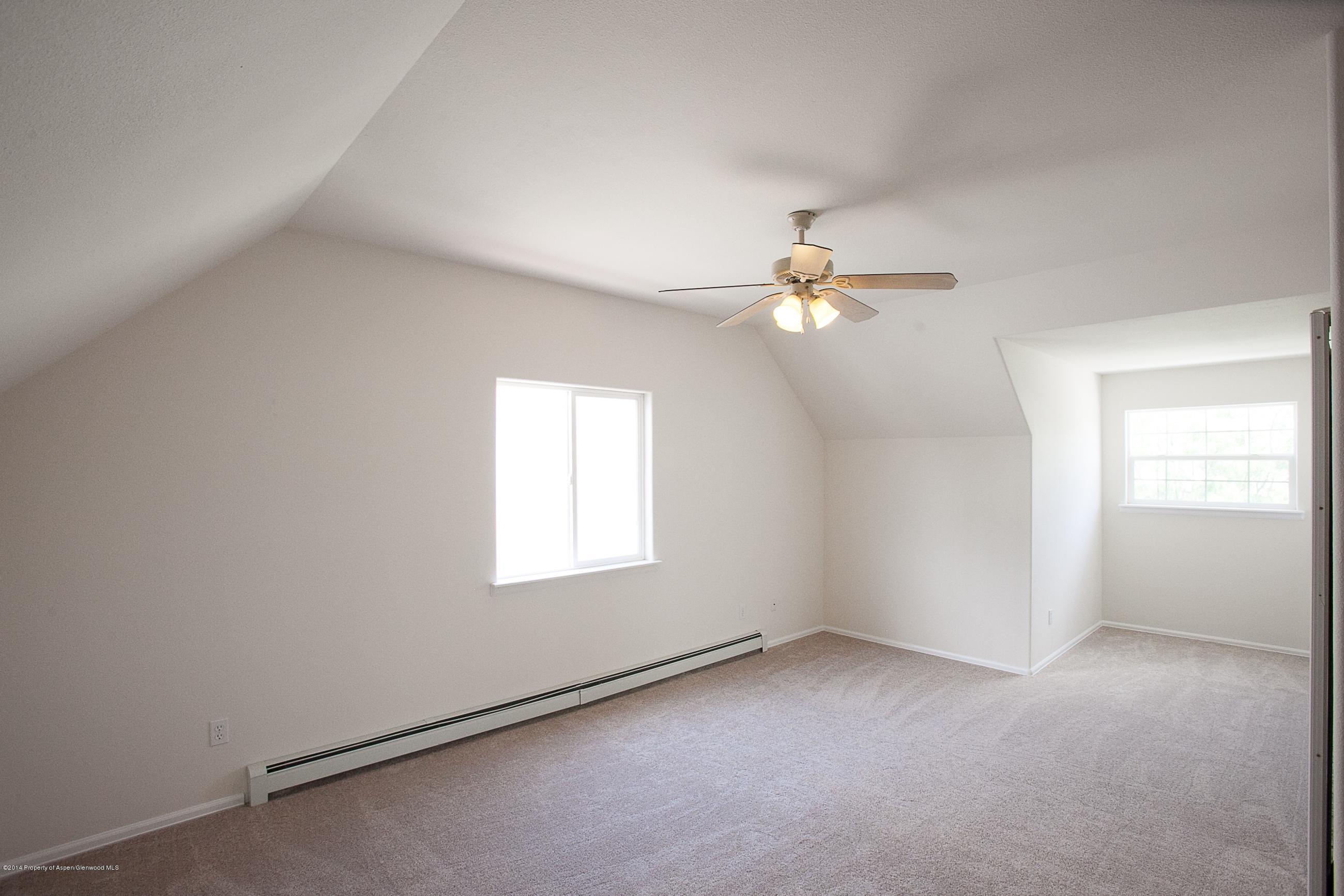 413 Evergreen Drive Rifle, CO 81650 - Photo 12 of 19 an empty room with windows and fan