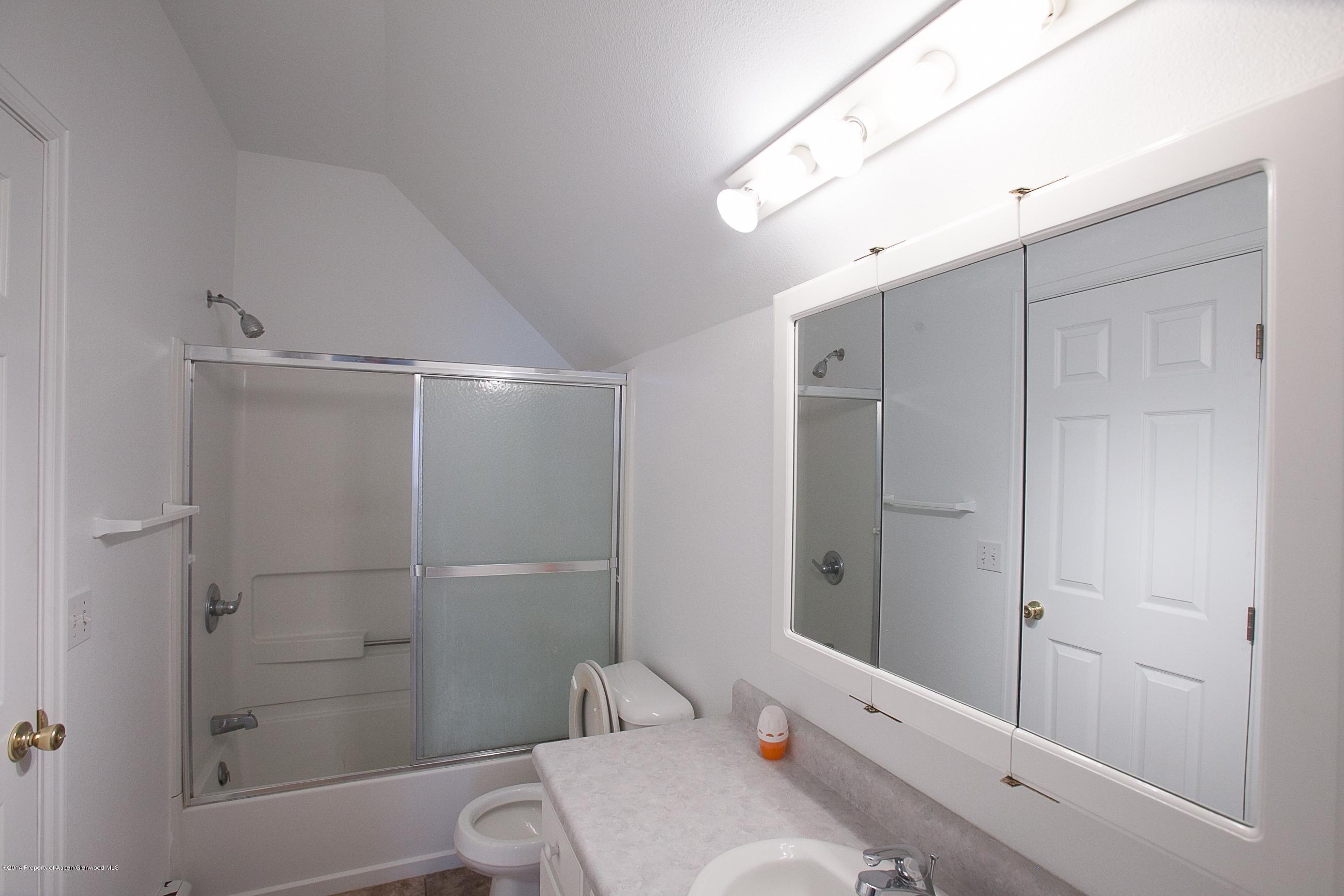 413 Evergreen Drive Rifle, CO 81650 - Photo 14 of 19 a bathroom with a sink a toilet and shower