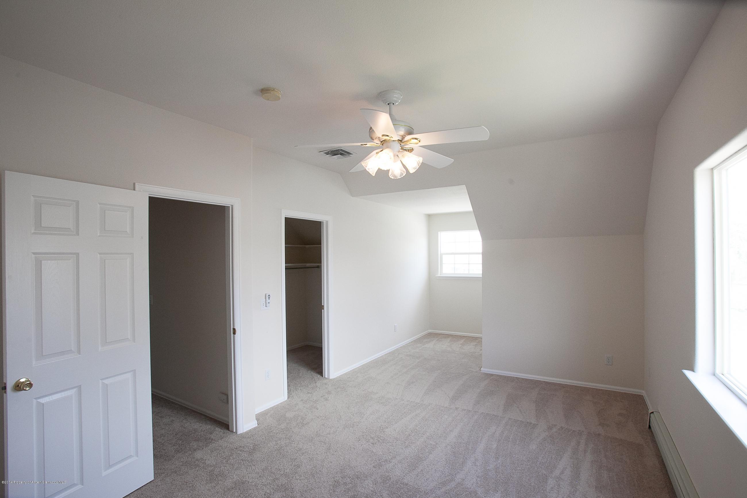 413 Evergreen Drive Rifle, CO 81650 - Photo 16 of 19 an empty room with chandelier fan and windows
