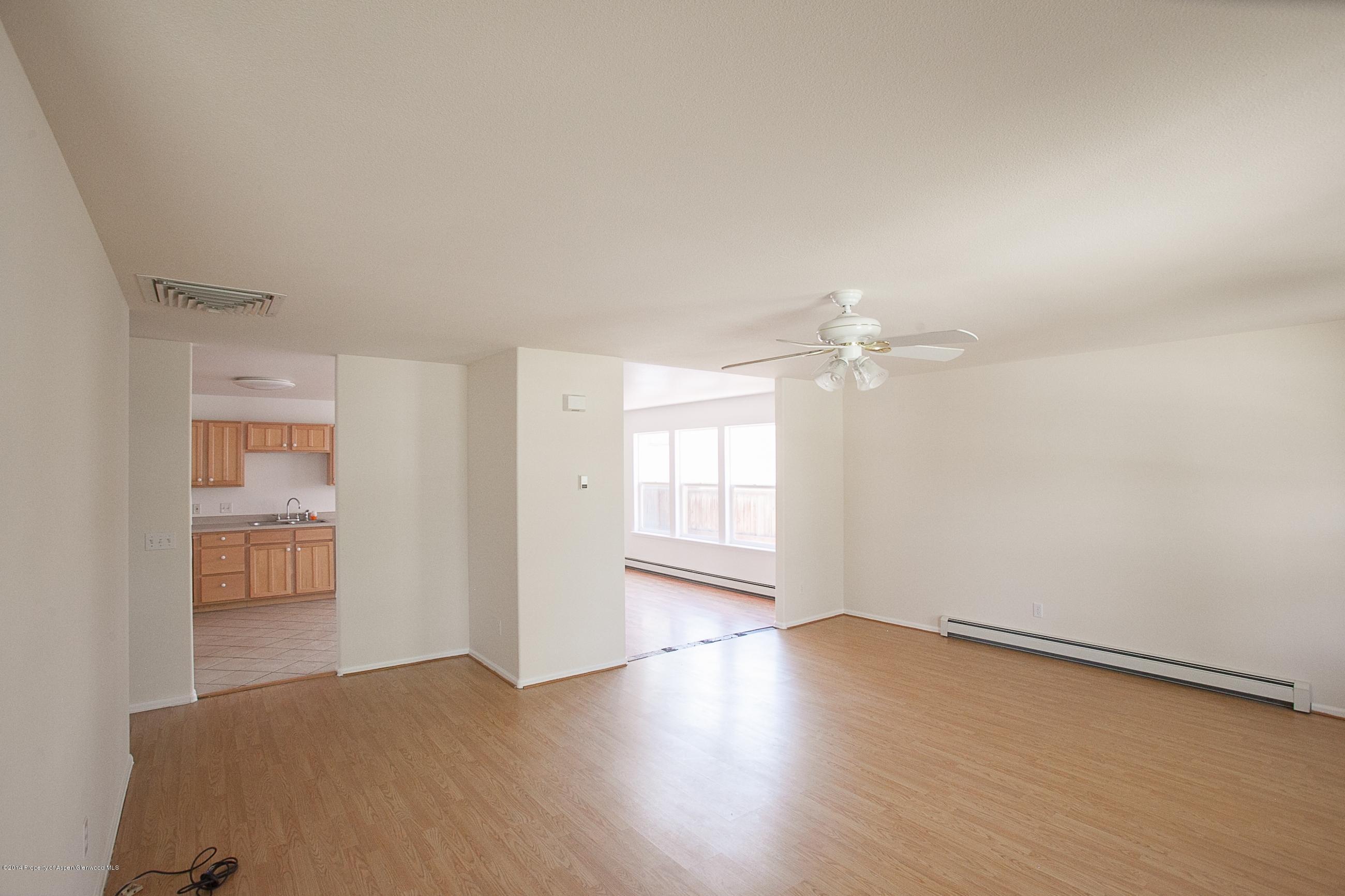 413 Evergreen Drive Rifle, CO 81650 - Photo 4 of 19 wooden floor in an empty room with a window