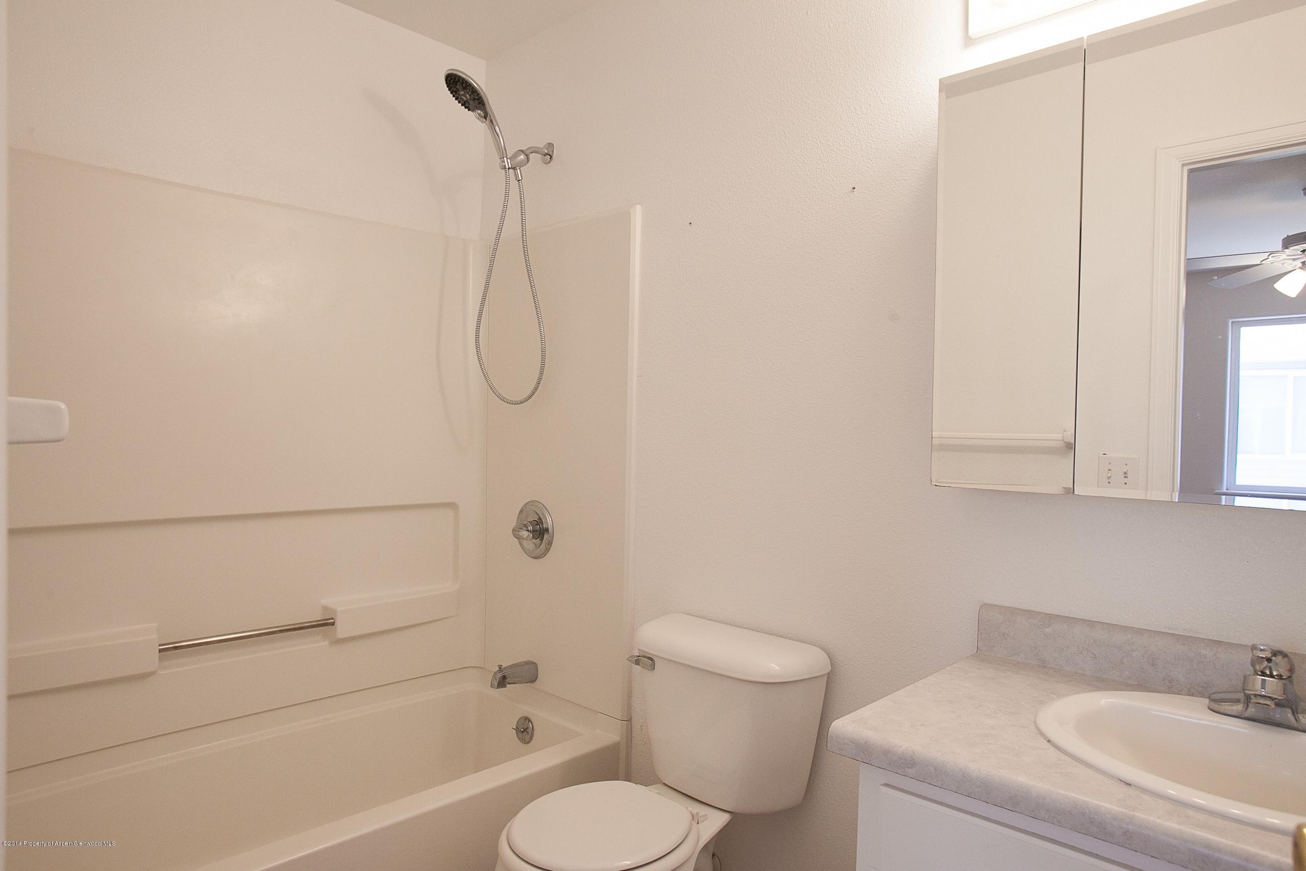 413 Evergreen Drive Rifle, CO 81650 - Photo 6 of 19 a bathroom with a toilet and a shower